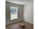 A light-filled bedroom offers wood-look flooring and a large window overlooking the outdoors at 14437 Sw 21St Pl, Ocala, FL 34481