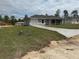 Well-maintained single-story home with a concrete driveway and freshly planted grass at 14437 Sw 21St Pl, Ocala, FL 34481
