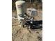 Close up of the well water storage tank, pump and plumbing on a sandy lot at 14437 Sw 21St Pl, Ocala, FL 34481