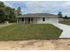 Charming single-story home with a fresh lawn, inviting front porch, and attached garage at 21 Pl # 14443, Ocala, FL 34481