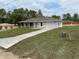 Newly constructed home with fresh lawn, paved driveway and attached garage at 21 Pl # 14443, Ocala, FL 34481