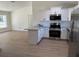Modern kitchen featuring stainless steel appliances, granite countertops, and white cabinets at 21 Pl # 14443, Ocala, FL 34481