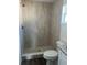 Bathroom featuring a tiled shower, toilet and granite countertop at 2871 Se 145 Pl, Summerfield, FL 34491