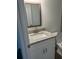Bathroom vanity with granite countertop, wooden framed mirror, and white cabinets at 2871 Se 145 Pl, Summerfield, FL 34491