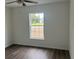 Bedroom featuring dark vinyl floors and a large double hung window at 2871 Se 145 Pl, Summerfield, FL 34491