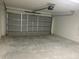Spacious garage with gray door, opener, and concrete floor provides ample parking at 2871 Se 145 Pl, Summerfield, FL 34491