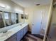 Bright bathroom with dual sinks, a large mirror, and a separate shower area at 3 Pine Radial Ln, Ocala, FL 34472