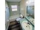 Well lit bathroom featuring a tub, toilet, window, and vanity with a mirror at 3 Pine Radial Ln, Ocala, FL 34472