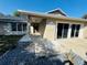 Covered entrance with stylish exterior paint, decorative rock landscaping, and modern sliding doors at 3 Pine Radial Ln, Ocala, FL 34472