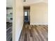 Hallway with laminate flooring and a view into the kitchen at 3 Pine Radial Ln, Ocala, FL 34472