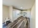 Open kitchen with white appliances, ample cabinet space, and wood-look flooring at 3 Pine Radial Ln, Ocala, FL 34472