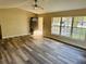 Living room with wood-look floors, a front door, and a large window at 3 Pine Radial Ln, Ocala, FL 34472