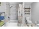 Bathroom with tiled tub, shower, and decorative shelving at 4237 Chambers St, Lake Wales, FL 33898