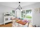 Cozy dining area with lake views, a charming vintage hutch, and a rustic wood table set for a meal at 4237 Chambers St, Lake Wales, FL 33898