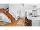 Open-concept kitchen with stainless steel appliances, a large island with seating, and a staircase leading upstairs at 4237 Chambers St, Lake Wales, FL 33898