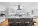 Modern kitchen features a large island with seating, stainless steel appliances, and sleek white cabinetry at 4237 Chambers St, Lake Wales, FL 33898