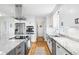 Stylish kitchen featuring stainless steel appliances, a large island with cooktop, and modern white cabinetry at 4237 Chambers St, Lake Wales, FL 33898
