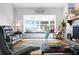 Bright living room with a lake view from a bay window, stone fireplace, and modern decor at 4237 Chambers St, Lake Wales, FL 33898