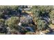 Aerial view showing the large backyard and pool, surrounded by mature trees and a circular driveway at 5425 Se 44Th Cir, Ocala, FL 34480