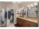 Bathroom featuring double sinks, granite countertops, and a walk-in closet at 5425 Se 44Th Cir, Ocala, FL 34480