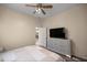 Bright bedroom features a ceiling fan and television atop a white dresser at 5425 Se 44Th Cir, Ocala, FL 34480