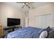 Bedroom showcases a ceiling fan, television, and large closet space at 5425 Se 44Th Cir, Ocala, FL 34480