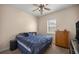 Bedroom features ceiling fan, window, and dresser with storage drawers at 5425 Se 44Th Cir, Ocala, FL 34480