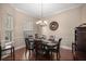 Formal dining room featuring elegant chandelier, wainscoting, and wood flooring at 5425 Se 44Th Cir, Ocala, FL 34480