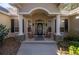 Inviting front entryway featuring rocking chairs and a decorative glass door at 5425 Se 44Th Cir, Ocala, FL 34480