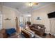 Comfortable living room boasting hardwood floors, ceiling fan, and bright lighting at 5425 Se 44Th Cir, Ocala, FL 34480