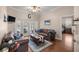 Cozy living room featuring hardwood floors, ceiling fan and French doors to patio at 5425 Se 44Th Cir, Ocala, FL 34480