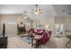 Spacious living room with cozy fireplace and ceiling fans for comfortable living at 5425 Se 44Th Cir, Ocala, FL 34480