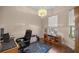Home office with built-in shelving, hardwood floors and natural light at 5425 Se 44Th Cir, Ocala, FL 34480