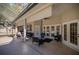 Covered patio with comfortable seating and view of the screened-in pool at 5425 Se 44Th Cir, Ocala, FL 34480