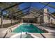 Backyard covered pool and spa with a screened-in lanai, perfect for outdoor entertainment at 5425 Se 44Th Cir, Ocala, FL 34480