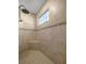 Walk-in shower with beige tile surround, mosaic accents and corner seat at 5425 Se 44Th Cir, Ocala, FL 34480