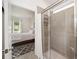 Bathroom with glass shower and view into the primary bedroom at 5430 Nw 46Th Lane Rd, Ocala, FL 34482