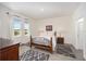 Bright bedroom with two large windows, neutral decor, and tile flooring at 5430 Nw 46Th Lane Rd, Ocala, FL 34482