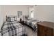 Cozy bedroom showcasing twin beds with plaid bedding and minimalist decor at 5430 Nw 46Th Lane Rd, Ocala, FL 34482