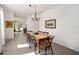 Dining area features a wood table and chairs, chandelier, and tile floors at 5430 Nw 46Th Lane Rd, Ocala, FL 34482