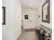 Entryway features tiled floor, small bench, and white trim at 5430 Nw 46Th Lane Rd, Ocala, FL 34482