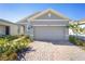 A well maintained home features an attached two-car garage and brick paver driveway at 5430 Nw 46Th Lane Rd, Ocala, FL 34482
