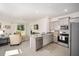 Open kitchen with breakfast bar featuring stainless steel appliances and tile floors at 5430 Nw 46Th Lane Rd, Ocala, FL 34482