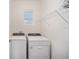 Bright laundry room with modern, front-load washer and dryer, and storage at 5430 Nw 46Th Lane Rd, Ocala, FL 34482