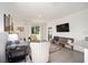 Open living room with neutral decor, tile floors, and sliding glass doors to the outdoors at 5430 Nw 46Th Lane Rd, Ocala, FL 34482