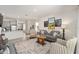 Cozy living room with modern artwork, striped armchairs, and tile flooring at 5430 Nw 46Th Lane Rd, Ocala, FL 34482