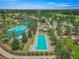 Community pool and golf course view with palm trees, lush landscaping and mature trees, a picturesque scene at 5616 Nw 39Th Ln, Ocala, FL 34482