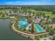 Aerial view showcases a resort-style pool, lap pool, and sunbathing area surrounded by lush landscaping at 5616 Nw 39Th Ln, Ocala, FL 34482