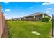 Spacious backyard with manicured lawn and mature landscaping, enclosed by a wooden fence at 5616 Nw 39Th Ln, Ocala, FL 34482