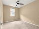 A cozy bedroom offers a ceiling fan and a window allowing natural light at 5616 Nw 39Th Ln, Ocala, FL 34482
